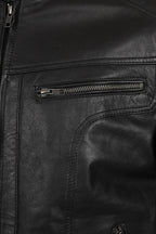 Close-up of a black leather jacket showing a zippered pocket and zipper details.