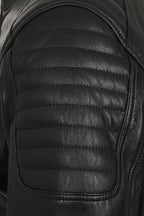 Close-up of a black leather jacket showing the quilted shoulder panel with horizontal stitching and smooth leather texture.
