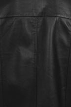 Close-up of a black leather jacket showing the back panel with a central vertical seam and stitched panel seams.